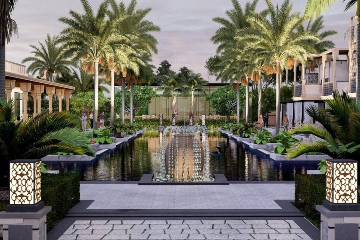 A pool area with palm trees, a fountain, and a modern building in the background.