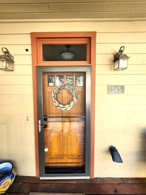 A wooden door with a glass panel, a wreath, and a number '245' on the wall. - Sunrise Ridge|Great Views,Hot Tub, +Pets, 10 Acres (Angel Fire)