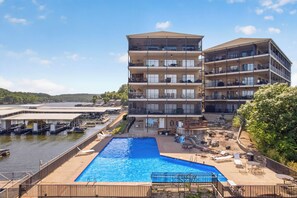 A multi-story hotel with a swimming pool and dock area. - Lake views! 3 Bdrm 3 Bath Falls condo (Lake Ozark)