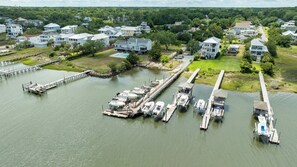 A marina with multiple docks and boats, surrounded by residential houses. - Sunny Days - Access The Masonboro Sound (Wilmington)