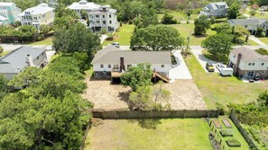A residential area with houses, a fenced yard, and a small garden. - Sunny Days - Access The Masonboro Sound (Wilmington)