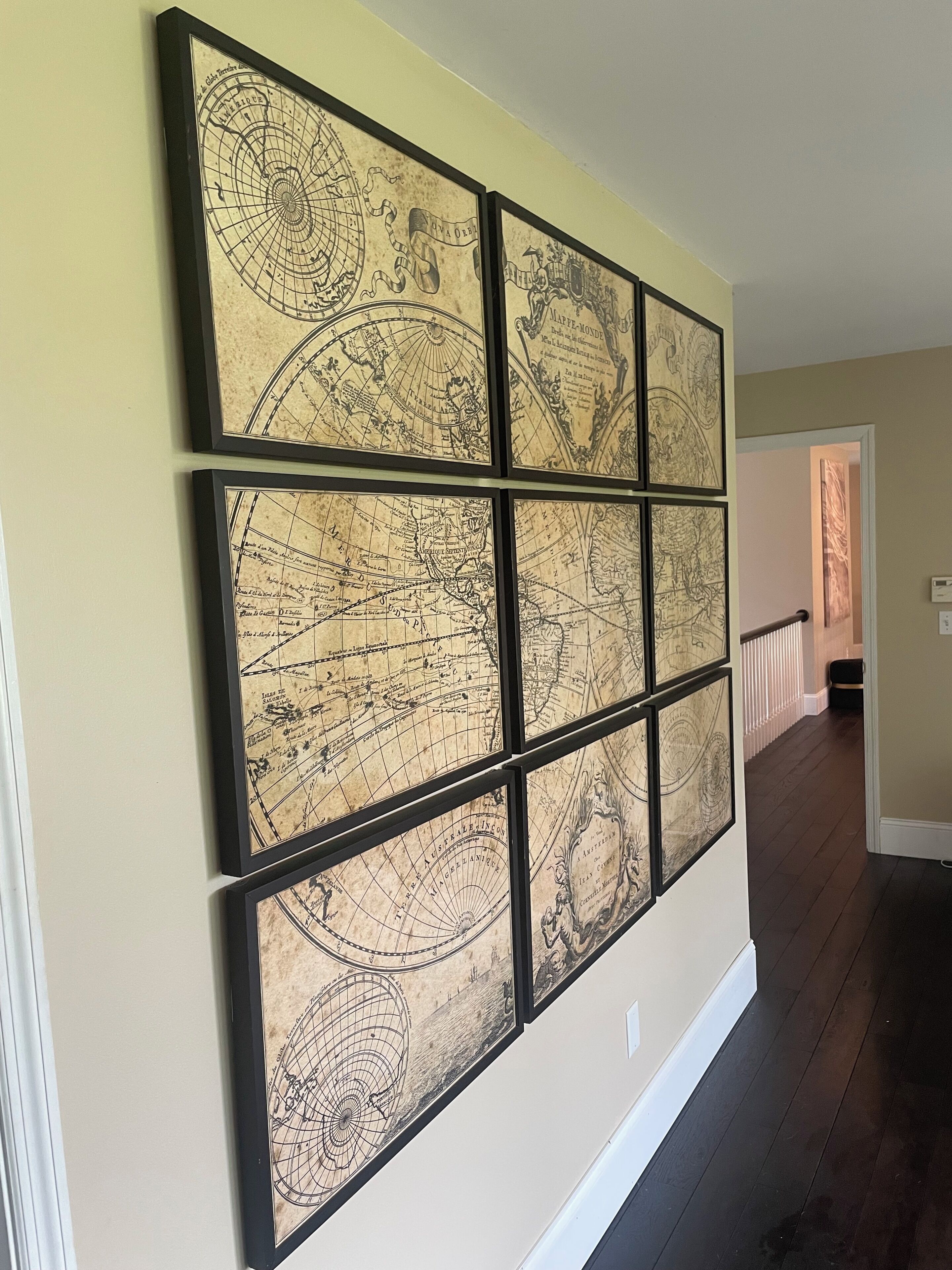 A hallway with a wall-mounted map artwork.