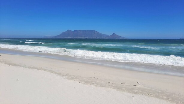 A beach with a mountain in the background. - Amazing View For Less Bloubergstrand Beachfront (Cape Town)