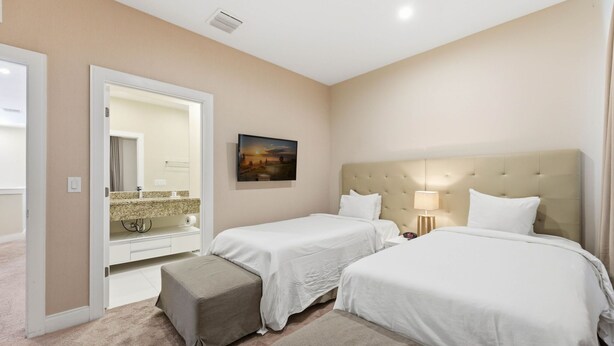 A hotel room with two beds, a bathroom with a mirror, and a painting on the wall. - Stylish 4 Ensuite Home Near Disney, Free BBQ Grill (Kissimmee)