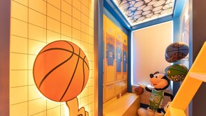 A basketball-themed room with lockers, a mascot, and a basketball hoop. - Orlando Most Incredible Themed 10br Villa (Clermont)