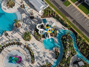 An aerial view of a resort with a large pool, water slides, and lounge areas. - Orlando Most Incredible Themed 10br Villa (Clermont)