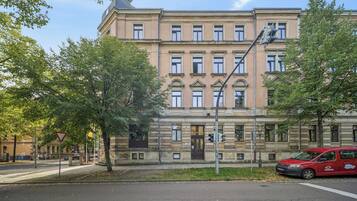 Ein mehrstöckiges Gebäude im klassischen Baustil, mit einer symmetrischen Fassade, gleichmäßig angeordneten Fenstern und einem zentralen Eingang.