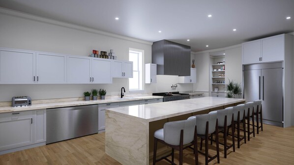 A modern kitchen with a central island, bar stools, stainless steel appliances, and white cabinetry.