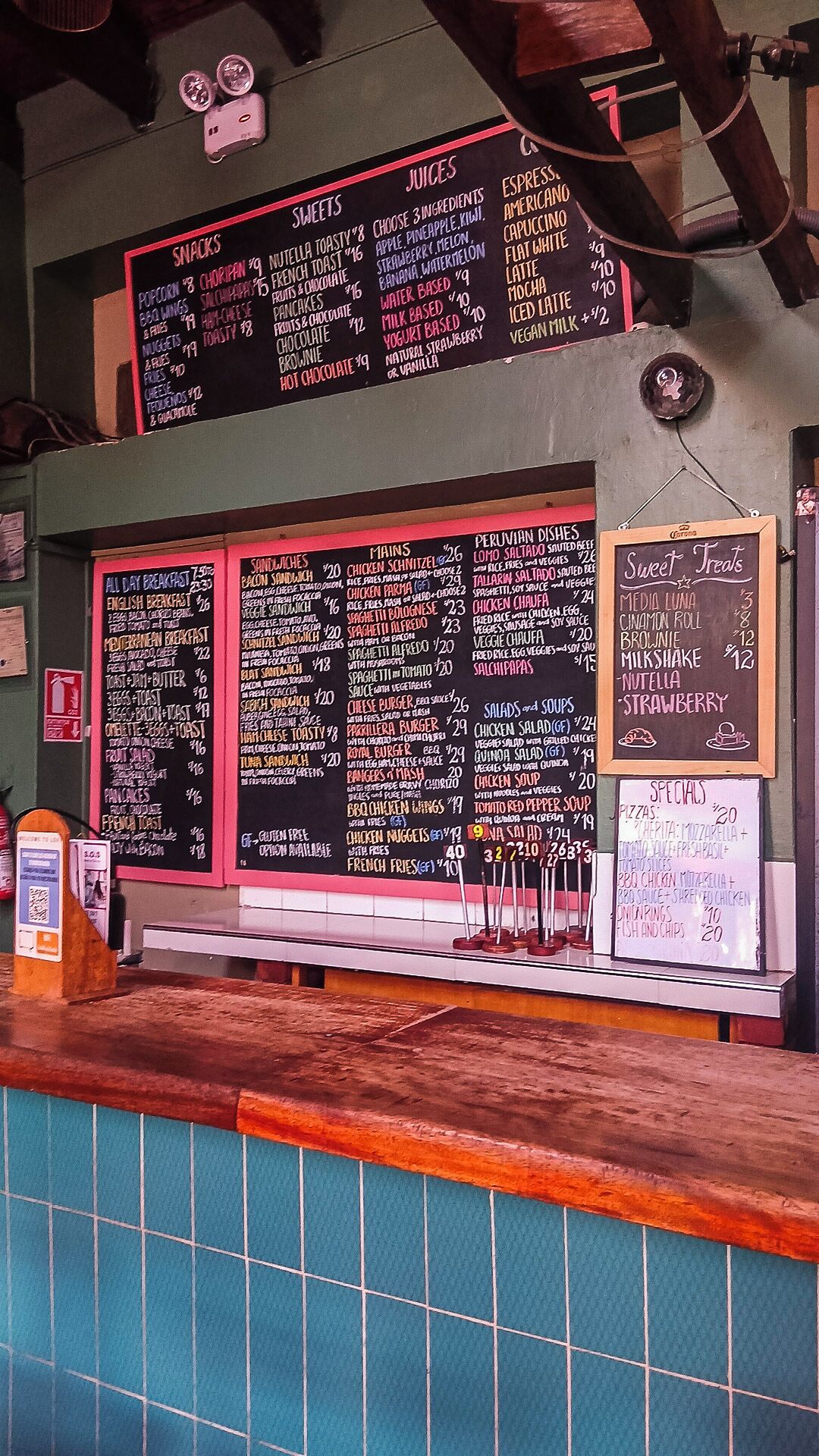 A menu board with various food and drink options, including snacks, mains, and desserts.