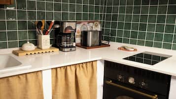 A kitchen with a coffee maker, toaster, and a decorative plate on the counter.