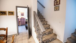 A staircase with patterned steps and a handrail, leading to an upper floor. - Casa rural La Bandolera (Grazalema)