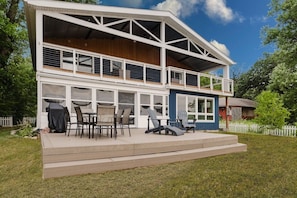Een tweelaags huis met een overdekte patio.