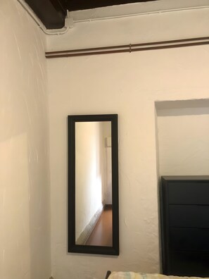 A room with a bed, a bedside table, a mirror, and a door. - Adapted Room with Mountain Views, Shared Terrace and WiFi (Moraime)