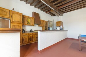 A kitchen with wooden cabinets, a countertop, and a stove.