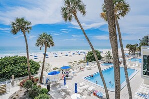 A resort with a pool, beach, and palm trees. - Gulf Front Getaway! Sand Castle I 307 (Indian Shores)