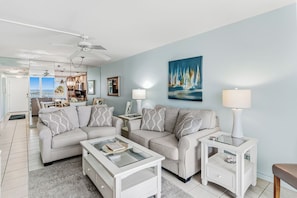 A living room with a sofa set, a coffee table, and a side table with a lamp. - Gulf Front Getaway! Sand Castle I 307 (Indian Shores)