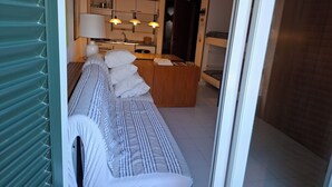 Et moderne interiør med en sofa, et træspisebord og et køkkenområde.