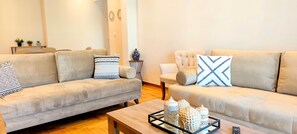 A modern living room with two sofas, a coffee table, and decorative items. - Sunny home in Acropolis (Athens)
