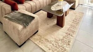 A modern living room with a sectional sofa, a coffee table, and a decorative floor lamp.
