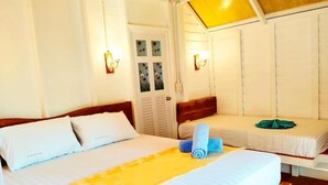 A hotel room with two beds, a bench, and a door with frosted glass panels. - koh phaluai beach cottage (Chang Wat Surat Thani)