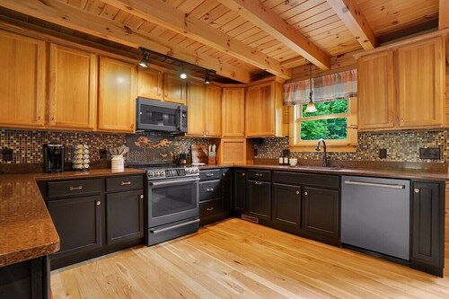 Triple Trac Lodge, upscale retreat in the countryside with 7 Bedrooms, hot tub, game room, and so much more. Plenty of fun for everyone!