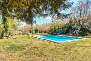 A rectangular swimming pool with a surrounding grassy area and trees. - Maison Huguette - Five Bedroom Villa, Sleeps 10 (Paradou)