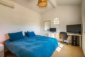 A bedroom with a bed, a desk with a computer, a chair, a mirror, and a window. - Maison Huguette - Five Bedroom Villa, Sleeps 10 (Paradou)