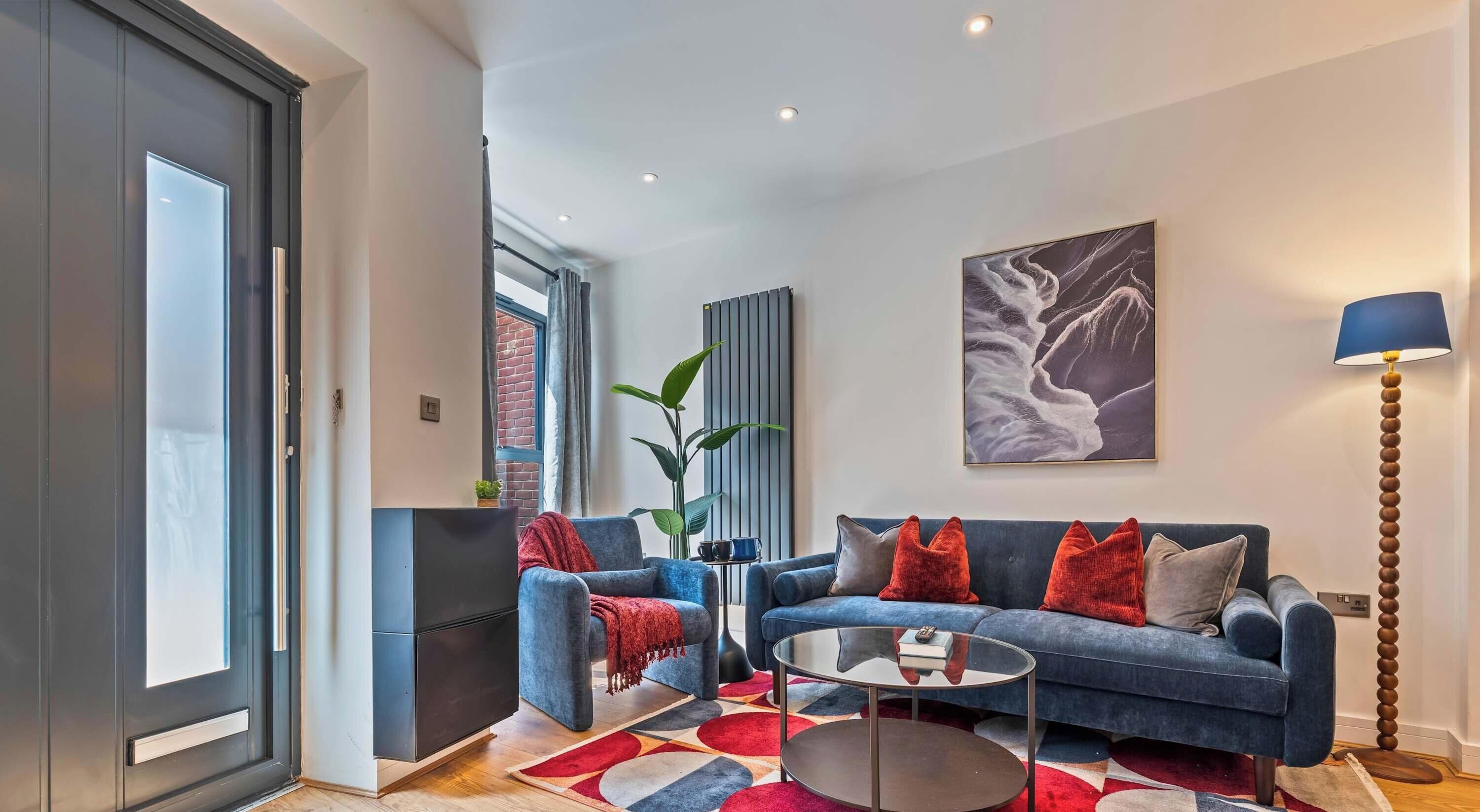 A modern living room with a sofa set, a coffee table, and a floor lamp.