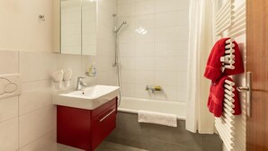 A bathroom with a shower, a sink, and a mirror. - Victoria B Studio - InspiringPlaces  (Zermatt)