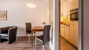 A modern kitchen with white cabinets and a built-in oven. - Victoria B Studio - InspiringPlaces  (Zermatt)