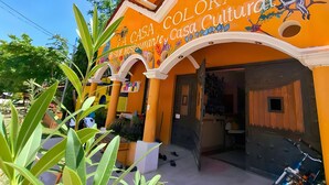A building with a sign reading 'Casa Colorada Restaurante Casa Cultural' and a motorcycle parked outside. - La Casa Colorada (San Benito)