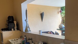 A kitchenette with a sink, a coffee maker, a toaster, and a hookah.
