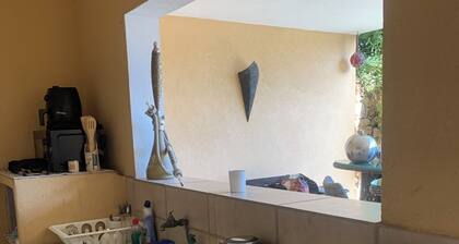Room for rent with shower and summer kitchen in a lush, green setting with a pool
