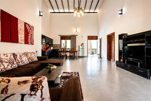 A spacious living area with a sofa, coffee table, and a fireplace.