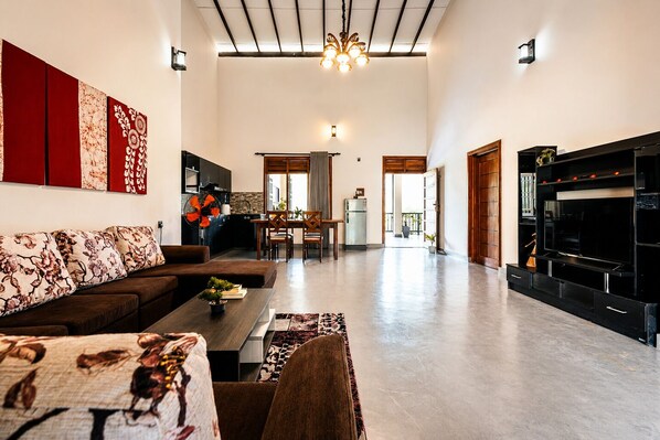 A spacious living area with a sofa, coffee table, and a fireplace.