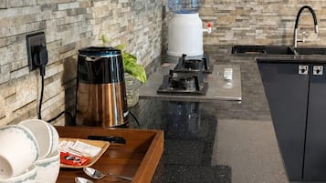Fridge, stovetop, electric kettle, cookware/dishes/utensils