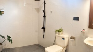 A bathroom with a toilet, a shower, a sink, and a potted plant. - Private Pool Villa (Tangalle)