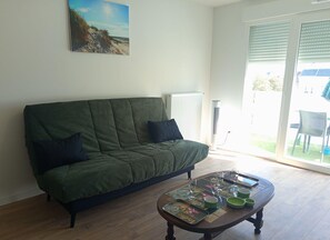 Ein Wohnzimmer mit einer Couch, einem Couchtisch und einem Gemälde an der Wand.