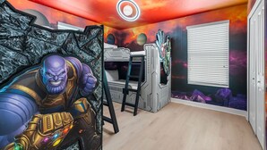 A room with a bunk bed, a mural of a cosmic scene, and a large poster of a character. - Themed 9BR Villa Pool Game Room Champions Gate (Davenport)