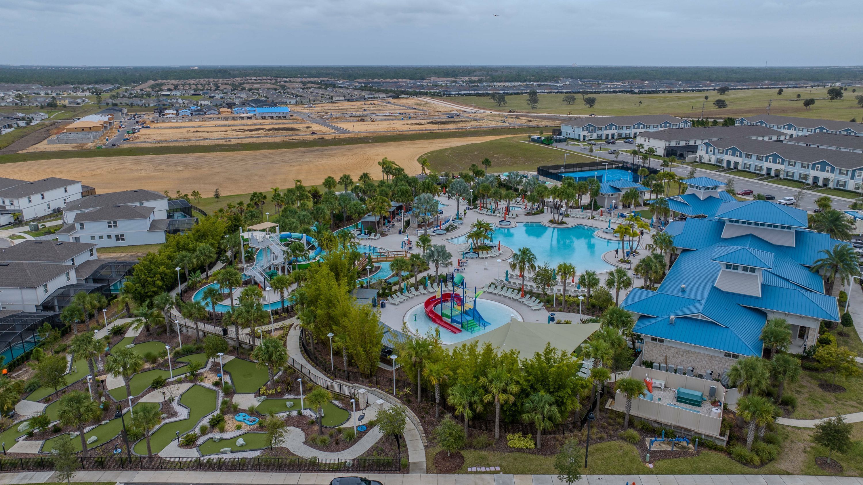 A resort with multiple swimming pools, a water park, and a variety of residential buildings.