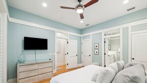 A bedroom with a bed, a dresser, a television, and a ceiling fan. - 2 Blocks to Beach | Screened-in Porch (Santa Rosa Beach)