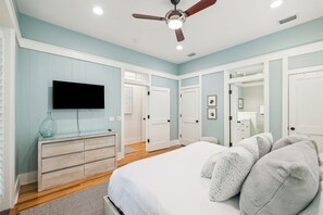A bedroom with a bed, a dresser, a television, and a ceiling fan. - 2 Blocks to Beach | Screened-in Porch (Santa Rosa Beach)