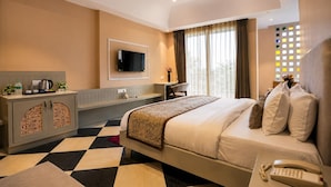 A hotel room with a bed, a desk, a television, and a minibar. - The HariMahal -A Luxury Hotel in Udaipur (Udaipur)