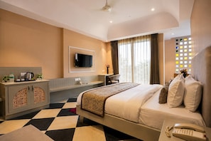 A hotel room with a bed, a desk, a television, and a minibar. - The HariMahal -A Luxury Hotel in Udaipur (Udaipur)