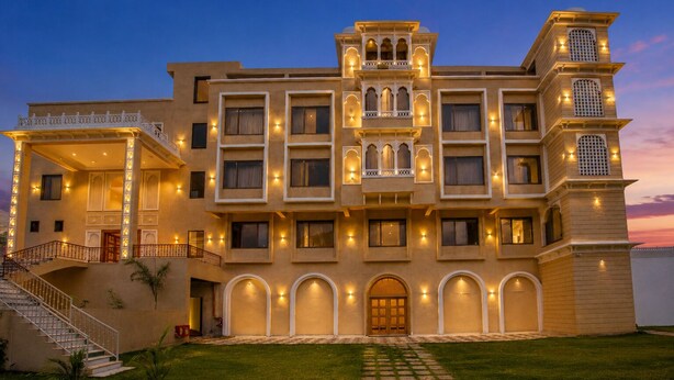 A multi-story hotel with a traditional architectural style, featuring balconies, arched doorways, and a well-lit facade. - The HariMahal -A Luxury Hotel in Udaipur (Udaipur)