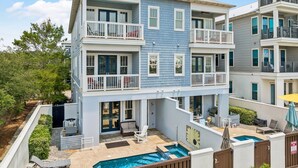 A multi-story residential building with balconies, a swimming pool, and outdoor seating areas. - Marimac's Maison|Private Pool|Elevator|Golf Cart (Inlet Beach)