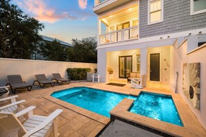 A two-story house with a swimming pool, outdoor seating, and a covered patio area. - Marimac's Maison|Private Pool|Elevator|Golf Cart (Inlet Beach)
