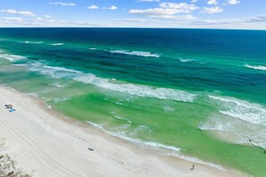A beach with clear turquoise waters, a sandy shore, and a few people. - Marimac's Maison|Private Pool|Elevator|Golf Cart (Inlet Beach)