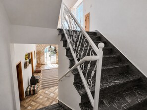 Eine Treppe mit schwarzen Marmorstufen und weißen Spindeln.