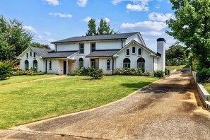 A two-story house with a driveway leading to the front door. - Hoover Furnished Stay | Families & Pros (Birmingham)